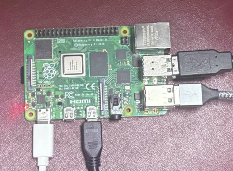 Raspberry Pi 4b model with four cables connected to it